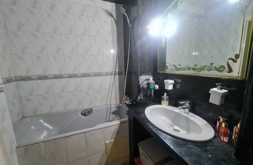 Sidi Bernoussi Bed & Breakfast | Cozy Villa bedroom with balcony : private bath accessed via shared space.