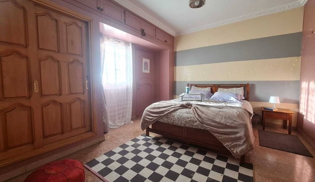Cozy Villa bedroom with balcony : private bath accessed via shared space.